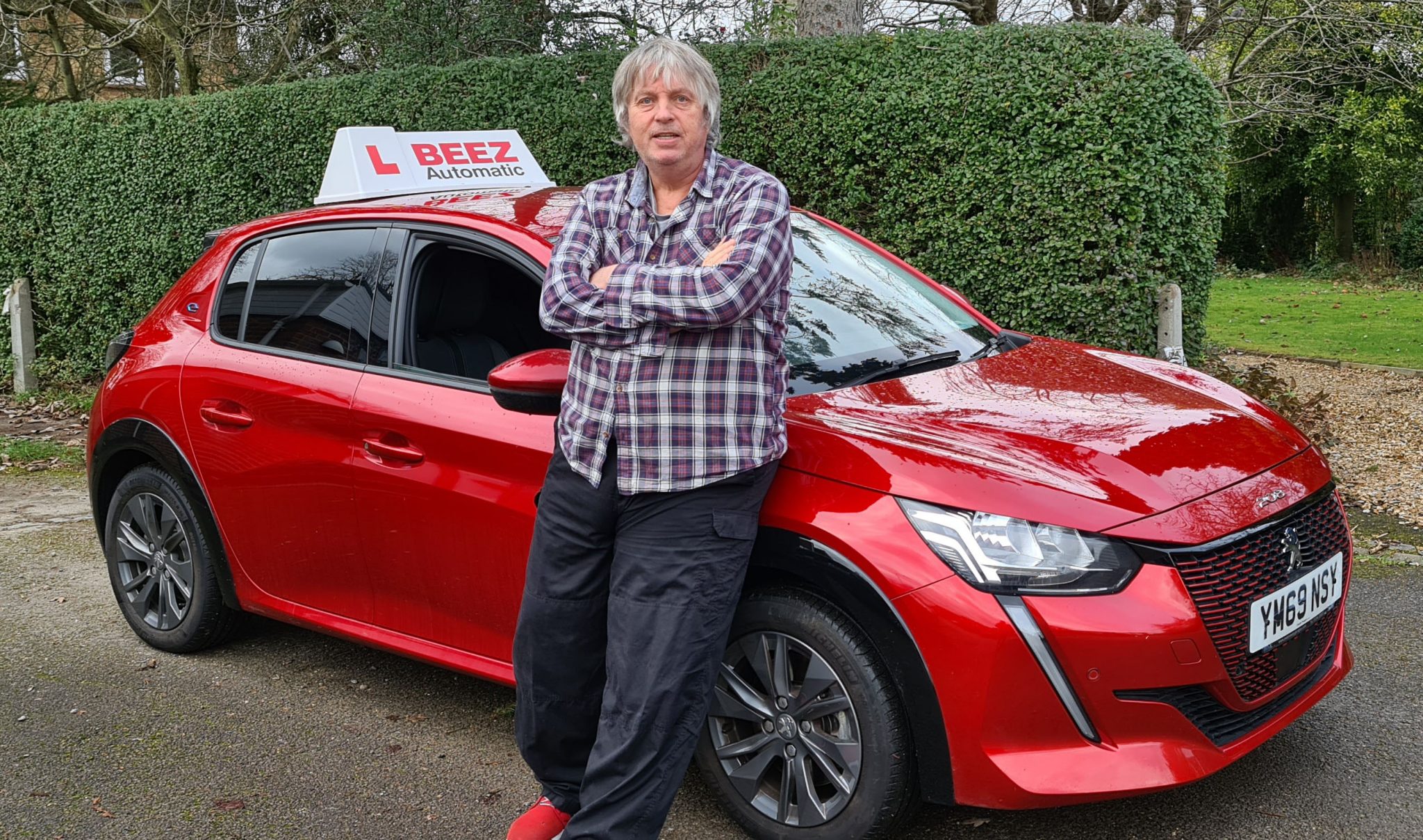 Graham Beisly with Beez Driving School electric car